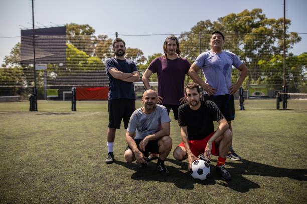 istock Friends standing on soccer field before the game 1254992691