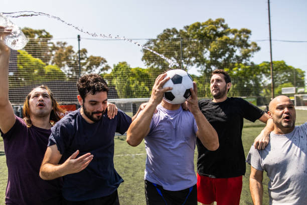 istock Teammates celebrating winning a match at soccer field 1254992743