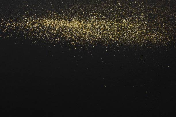 istock Gold glitter on black background. Holiday abstract texture 1254992897