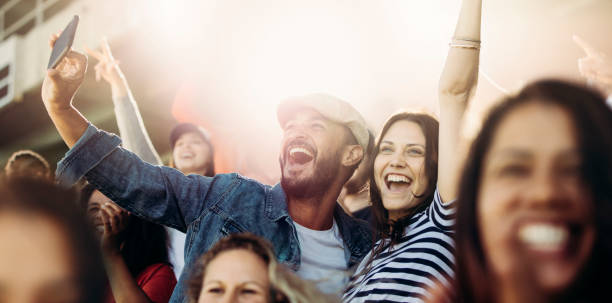 istock Couple taking selfie while watching a match at stadium 1254993800
