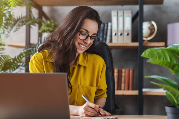 istock Smiling young female freelancer working at home 1254993813