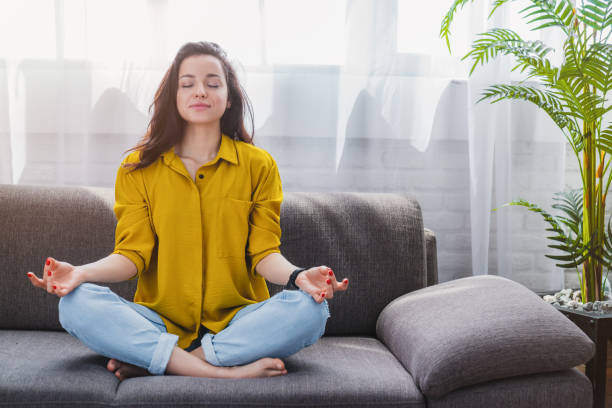 istock Peaceful millennial girl deeply meditating while doing breathing yoga exercises and meditating 1254993941