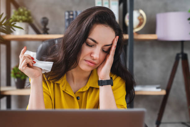 istock Sick business woman getting flu in office while feeling head pain 1254993942