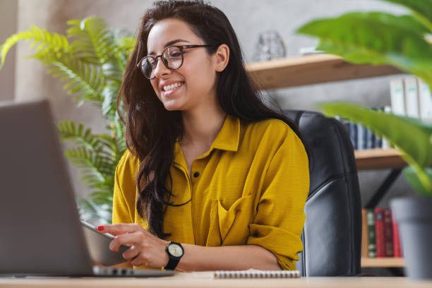 istock Beautiful young woman on the workplace using digital tablet 1254993990