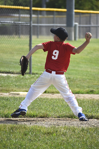 Boy wearing a baseball helmet and a glove