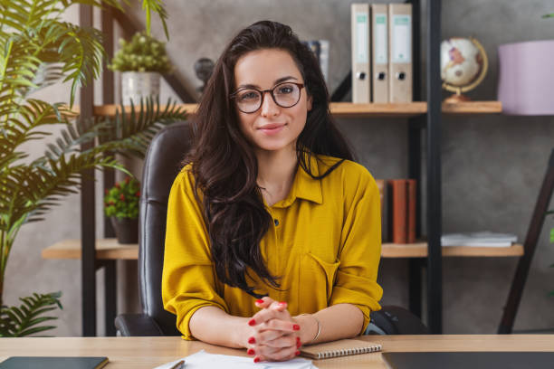 successful business woman working at office with look at camera - business looking at camera office new imagens e fotografias de stock