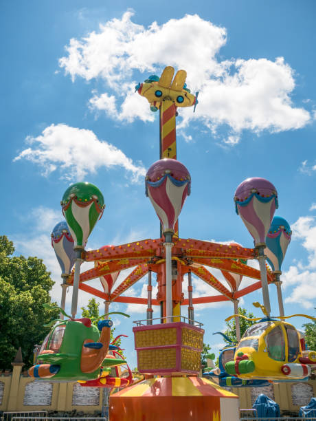 istock Amusement ride in a fun park against blue sky. 1254994898
