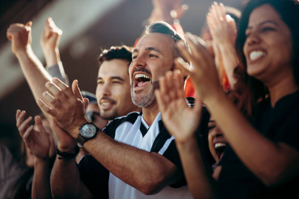 group of soccer fans cheering their national team - sport crowd fan stadium imagens e fotografias de stock