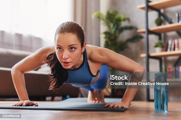 Beautiful Young Sports Lady Doing Push Ups While Workout At Home Stock Photo - Download Image Now