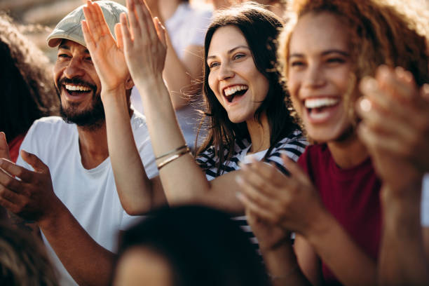 Group of spectators cheering for their team victory
