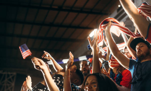 istock Soccer supporters cheering with USA flags 1254996339