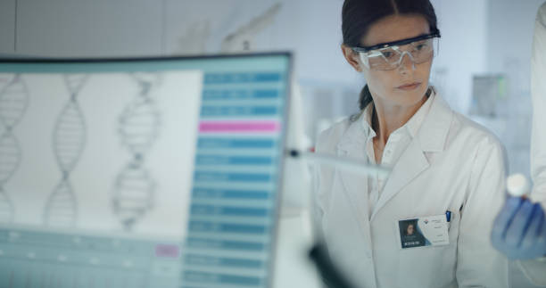 istock Female scientist studying DNA mutations. Research partner in background 1254996462