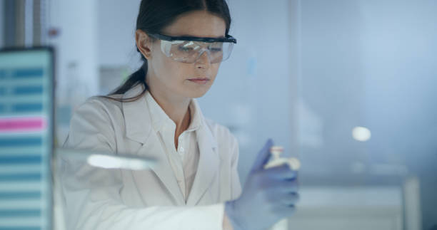 istock Female scientist studying DNA mutations. Research partner in background 1254996463