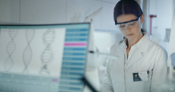 istock Female scientist studying DNA mutations. Research partner in background 1254996475