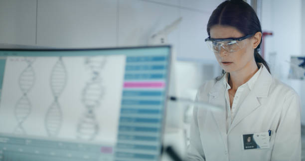 istock Female scientist studying DNA mutations. Research partner in background 1254996479