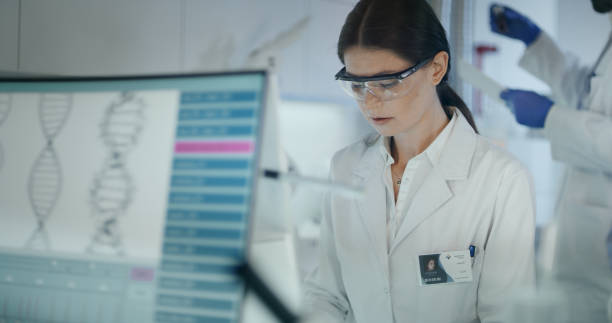 istock Female scientist studying DNA mutations. Research partner in background 1254996481