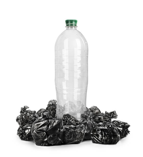 istock Recycling concept. A plastic bottle surrounded by trash bags. 1254996499