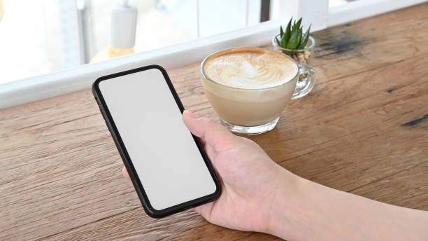 istock Woman's hand holding smartphone 1254997782