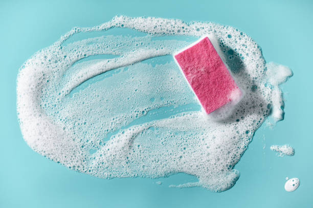 istock Cleaning sponge and a soapy foam on a blue background. Cleaning concept, cleaning service 1254998046