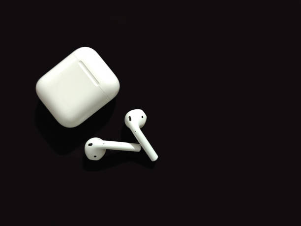 Airpod with black background Use this image for music, branding, etc earbud stock pictures, royalty-free photos & images