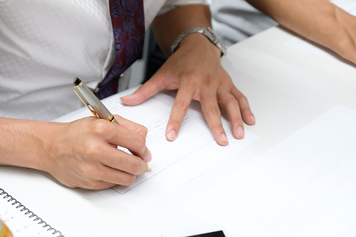 A Japanese businessman fills out a questionnaire at a seminar.