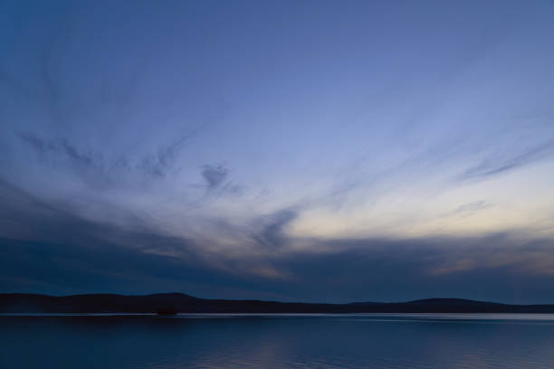 beautiful clouds during blue hour over the lake.