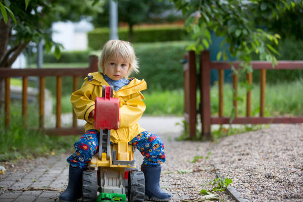 istock Cute child, blond boy, playing on playground on a cloudy day 1255001920