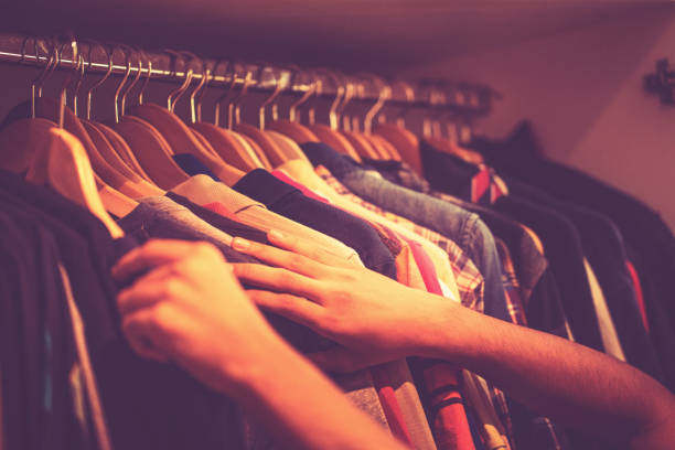 istock Man selecting casual shirt from wardrobe 1255002531