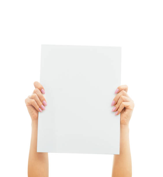 istock Female hands holding and rise up blank sheet poster. 1255005579