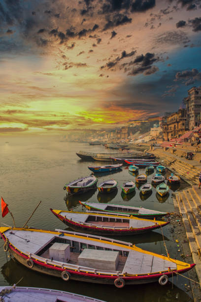 wooden boats lined up on the Ghats of Varanasi, early morning early sunrise scene of Ghats of Varanasi, India varanasi stock pictures, royalty-free photos & images