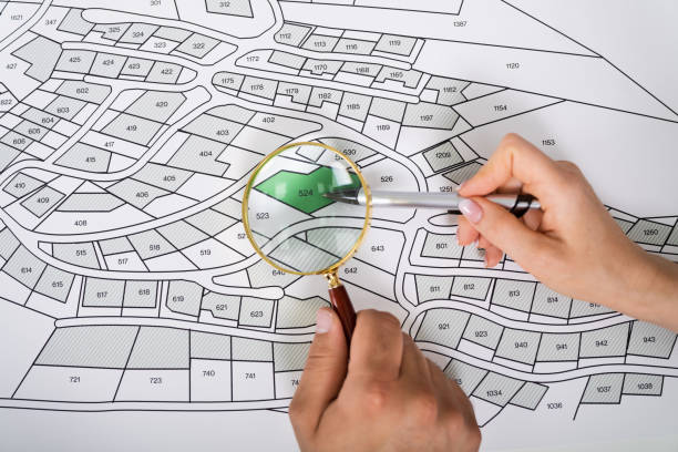 istock Close-up Of Human Hand Holding Magnifying Glass 1255007485