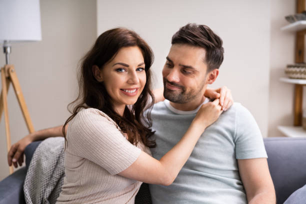 istock Sitted Happy Man And Woman On Sofa Or Couch 1255007603