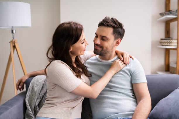 istock Sitted Happy Man And Woman On Sofa Or Couch 1255007612
