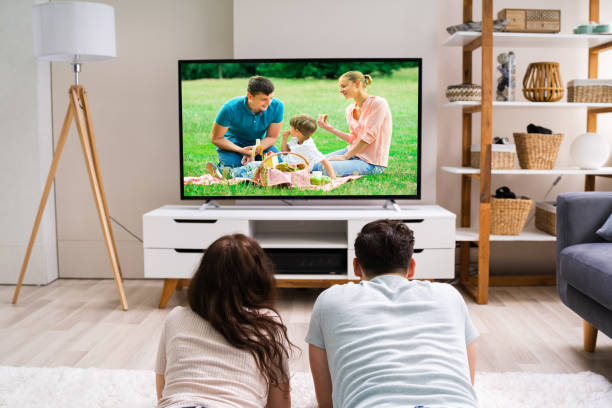 istock Happy Family Watching TV Or Film 1255007798