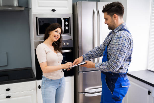 istock Happy Customer Woman Signing Plumber Invoice 1255007871