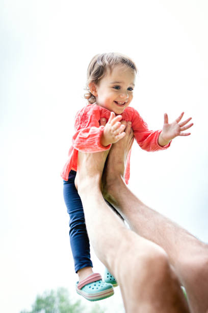 istock Dad playing with his daughter outdoors in the nature 1255008587