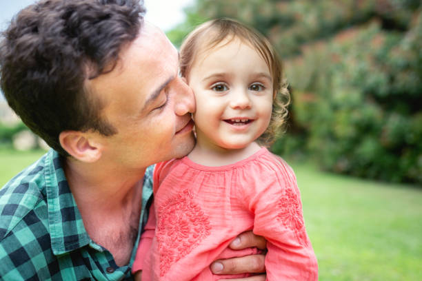 istock Dad playing with his daughter outdoors in the nature 1255008663
