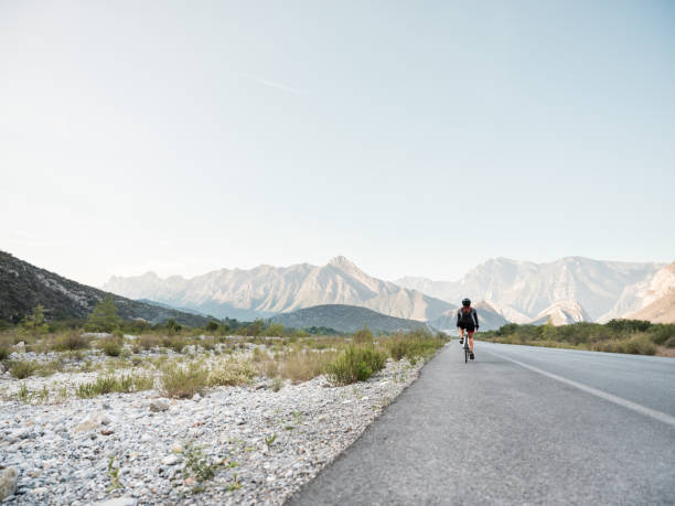 istock Back view of cyclist on the round 1255009051