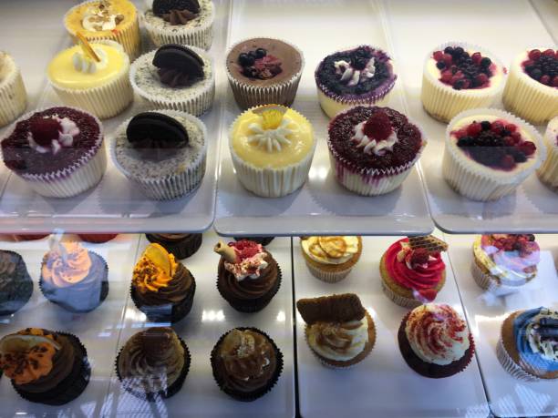 istock Lots of colorful cupcakes on shelf 1255009218