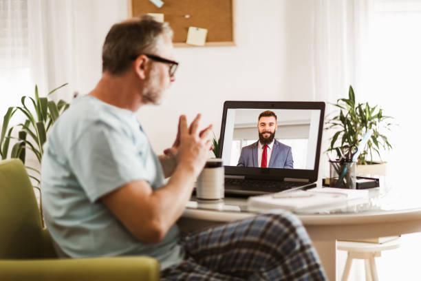 istock Businessman chatting with his colleague. Working at home. 1255011392