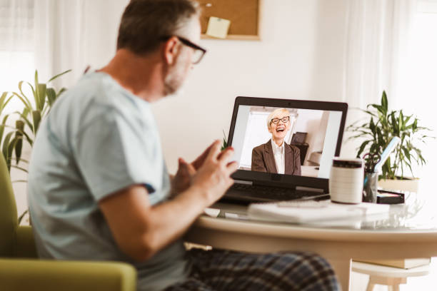 istock Businessman chatting with his colleague. Working at home. 1255011494