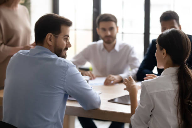istock Rear view businesswoman speaking, discussing project at corporate meeting 1255011663