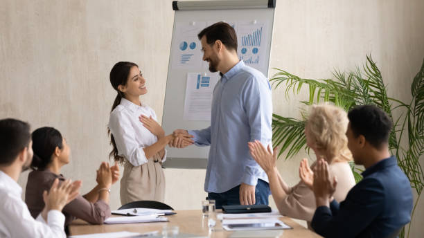 istock Smiling executive shaking successful Arabic businesswoman hand at briefing 1255011675