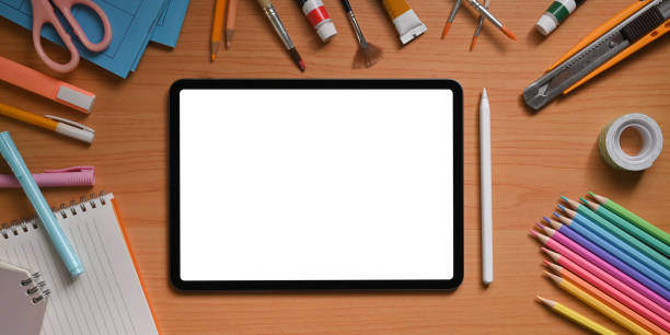istock Top view image of artist workspace is surrounding by white blank screen computer tablet and stuff. 1255011903