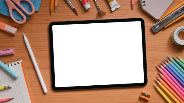 istock Top view image of artist workspace is surrounding by white blank screen computer tablet and stuff. 1255012070