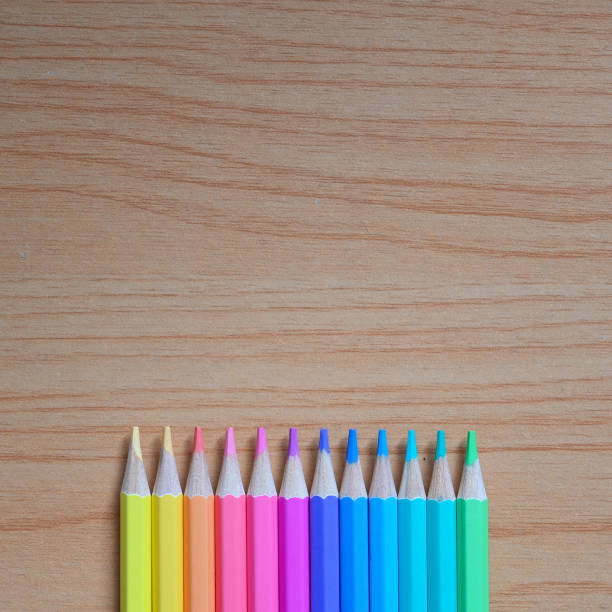 istock Top view image of Multi-colored sharpened pencils is putting on a wooden table. 1255012656