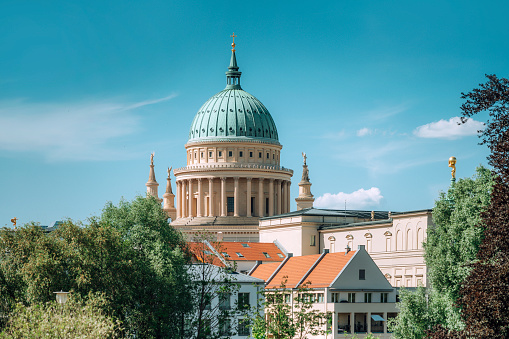 golden domes and crosses of the Smolny Cathedral in sunny weather against the background of a gloomy sky. High quality photo