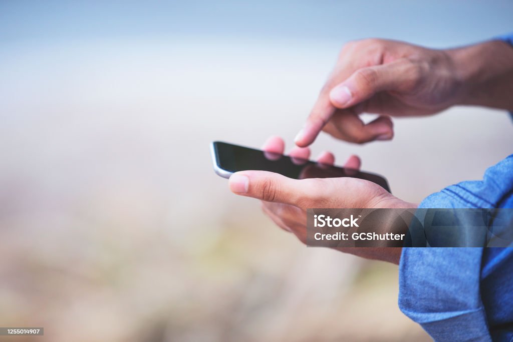 Millennials and Technology Social Media, Internet, Smartphone, Modern Generation - Man holding a modern smartphone Smart Phone Stock Photo
