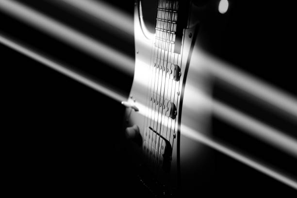 istock White electric guitar. Music concept. Creative style with light shadows. 1255016028