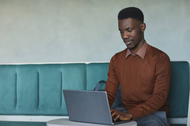 istock African-American Man Using Laptop in College 1255016638